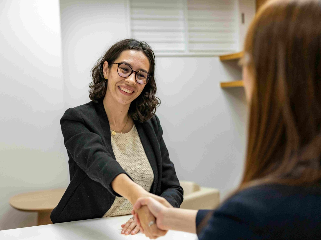 Managerin schüttelt Hand – Ratgeber Management Studium: Campus M University.