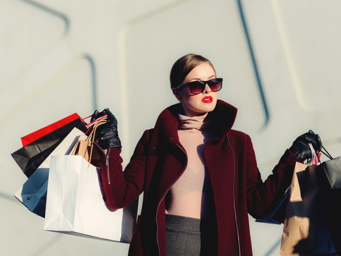 Business Frau mit Sonnenbrille und Shoppingtüten in den Händen - Ratgeber Fashion Business Studium: Campus M University.